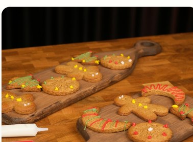Decorated gingerbread cookies on a wooden board